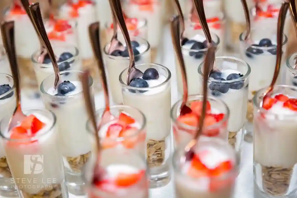 Mini parfaits with berries and yogurt in glasses.