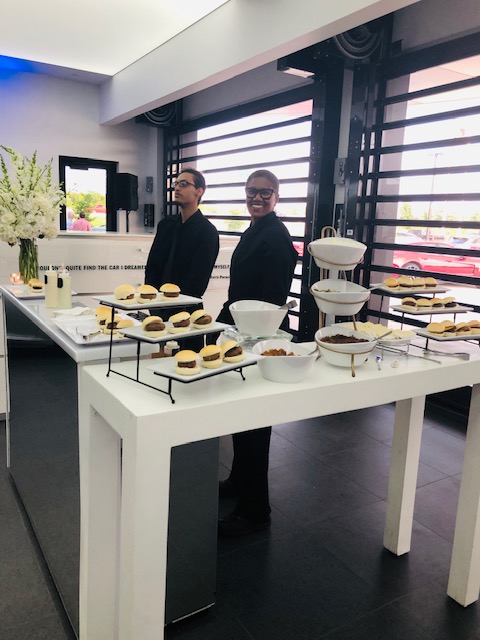 Catering staff with desserts at event reception.