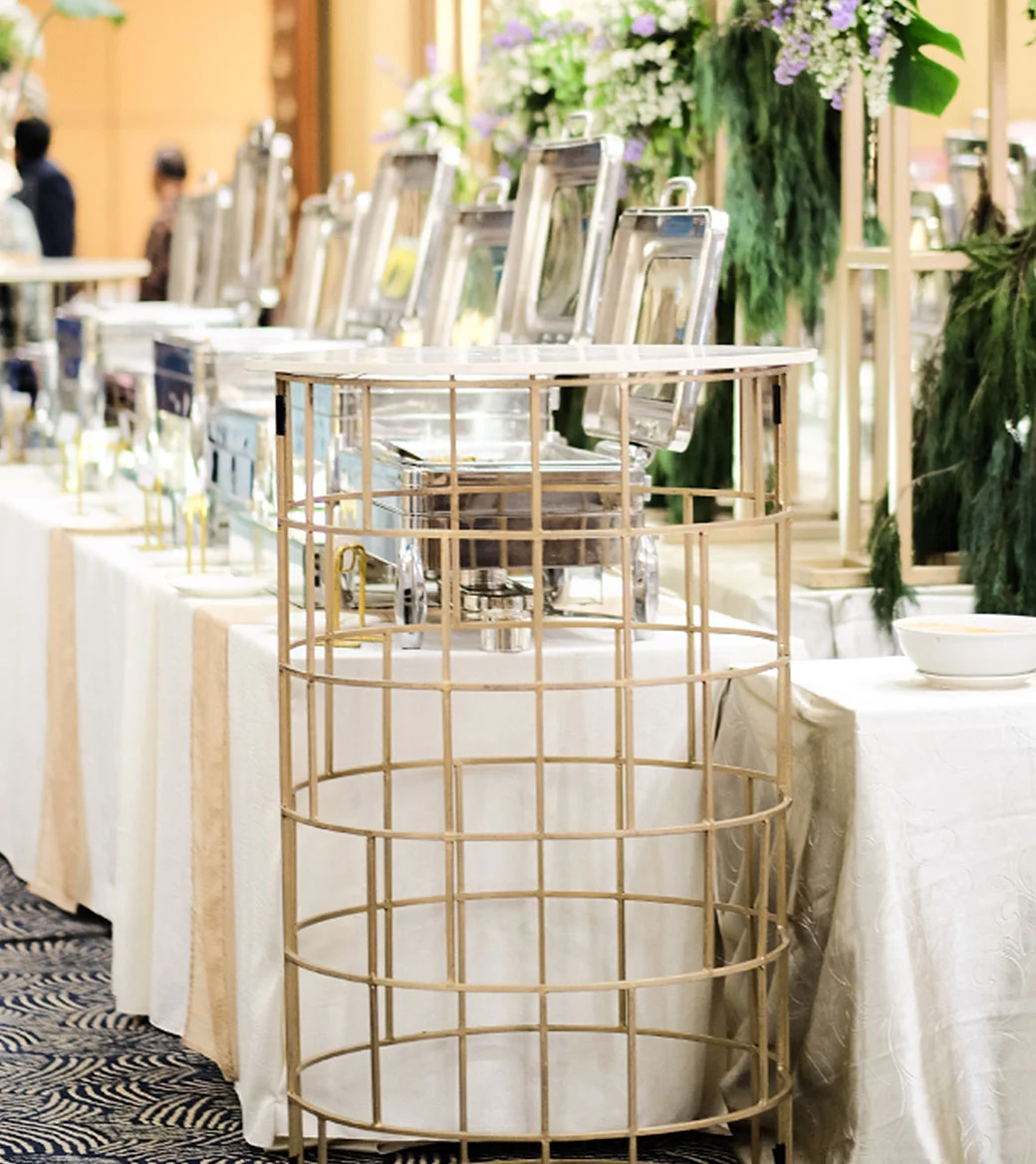 Buffet tables with chafing dishes at event.