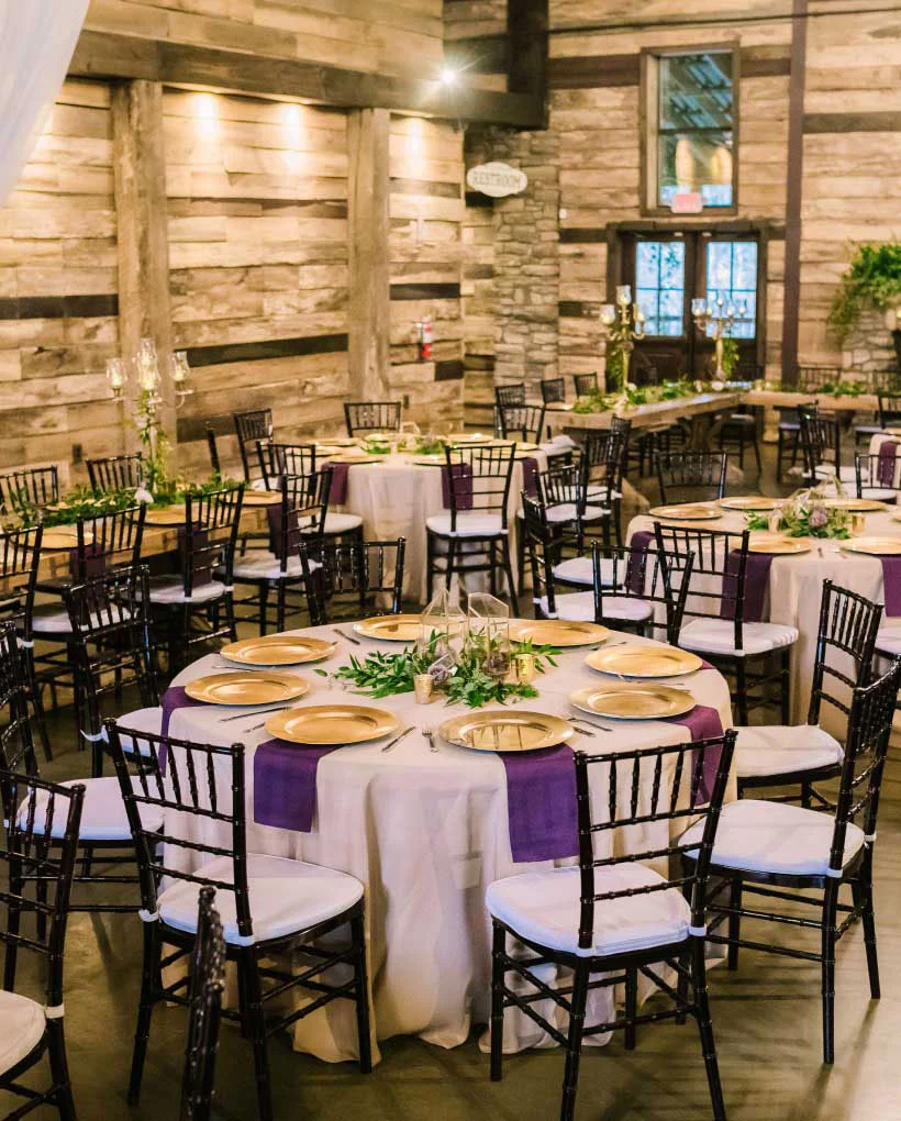 Elegant rustic wedding reception hall setup.