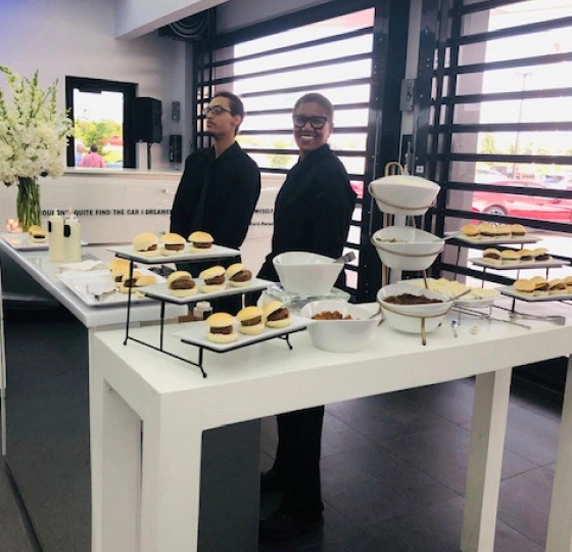 Catering staff with dessert buffet at event.