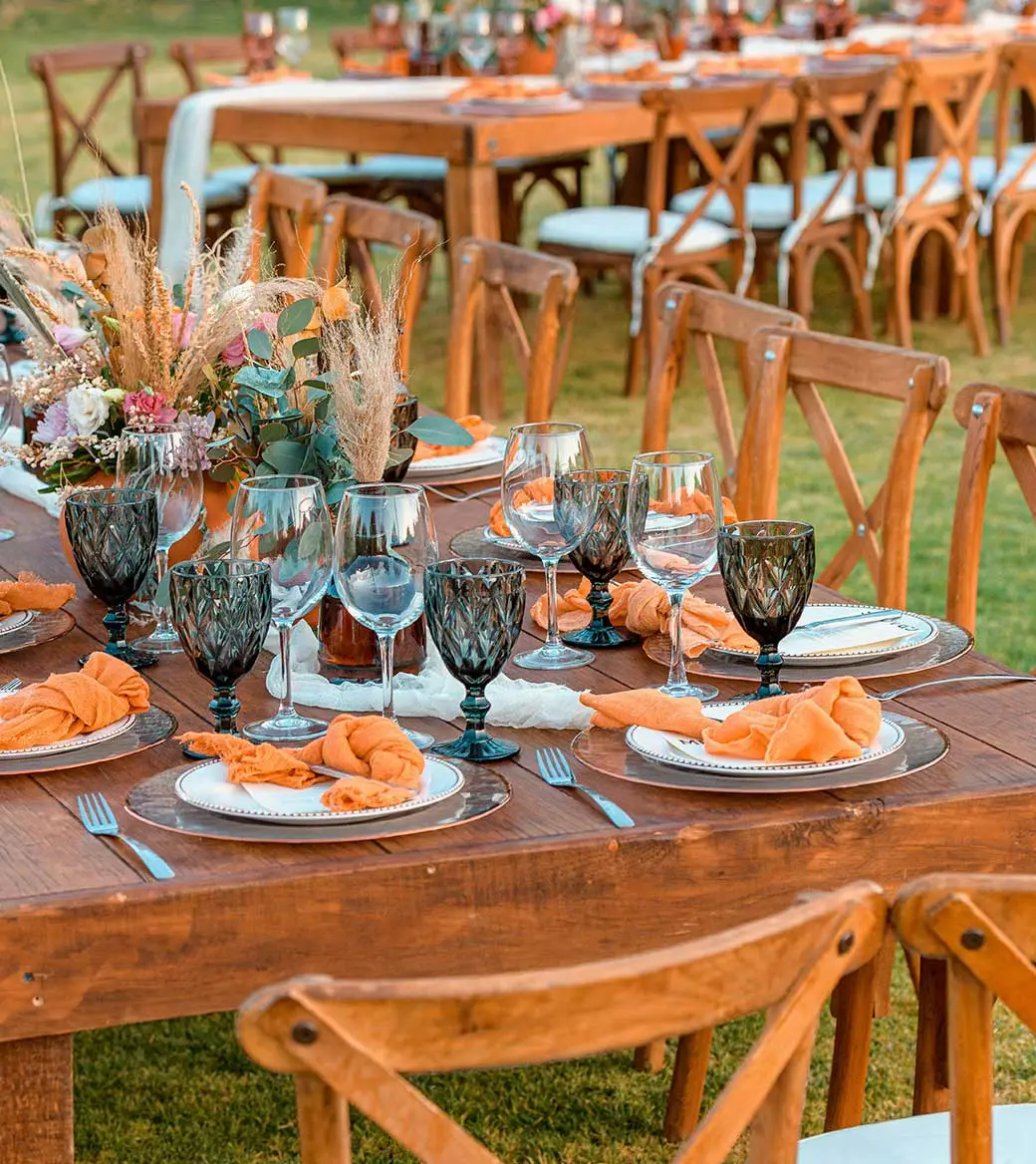 Outdoor banquet table setting with rustic decor.