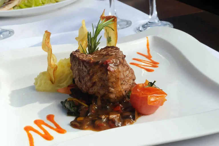 Gourmet beef dish with potatoes and sauce.