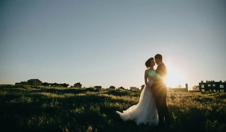 Couple embraces in sunset field