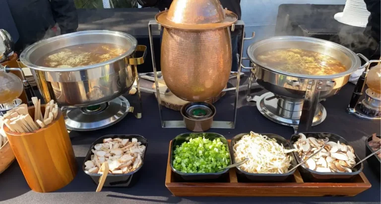 Buffet with ramen and fresh ingredients.