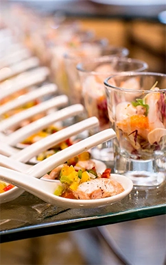 Elegant seafood appetizers in spoons and glasses.