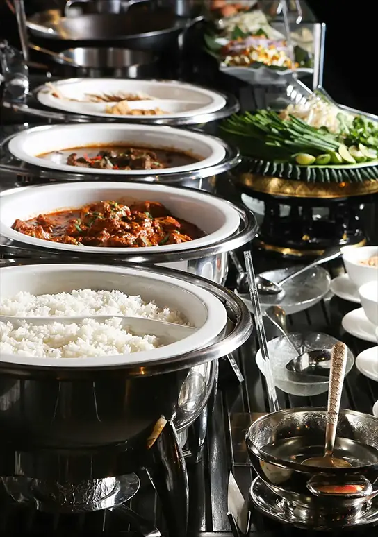 Buffet with rice, curry, and fresh vegetables.