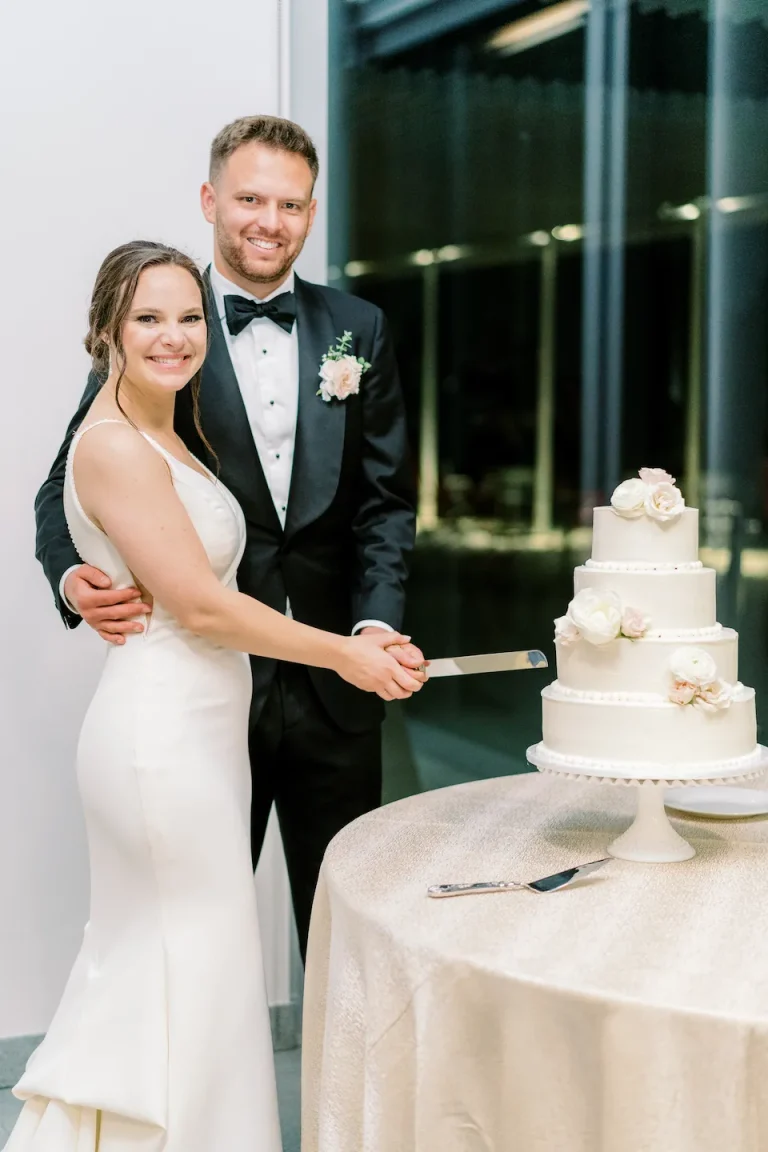 Bride and groom cutting wedding cake